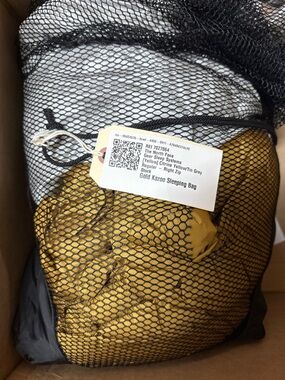 The North Face Gold Sleeping Bag in Black Mesh Stuff Sack